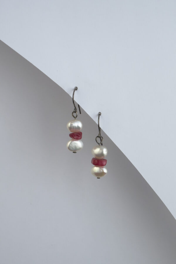 dangling earrings with freshwater pearls and small red minerals