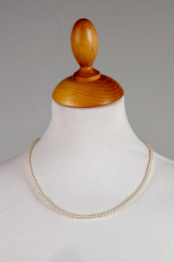 Necklace made of small natural white plastic pearls