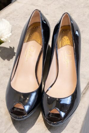 Black patent leather high-heeled shoes.