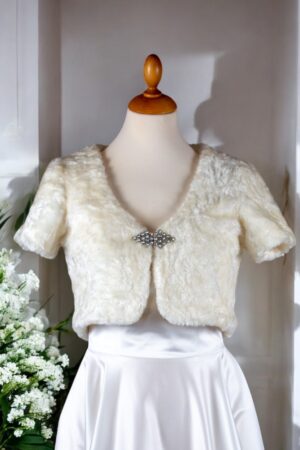 A natural white faux fur bolero.