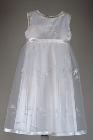 Festive children's dress made of natural white tulle with a fluffy skirt