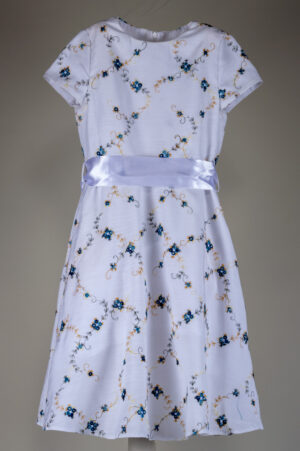 festive children's dress made of fabric with multicolored embroidery
