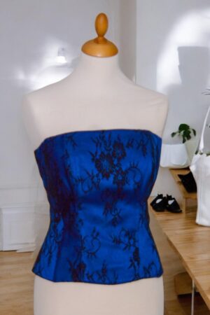 Blue corset covered with black lace