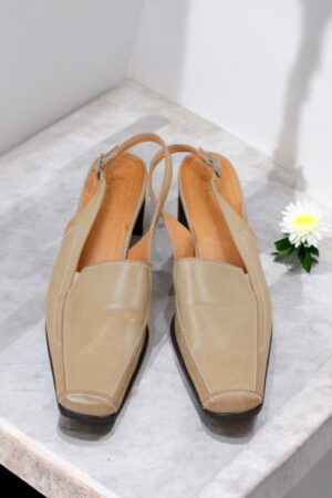 Beige leather open heel shoes.