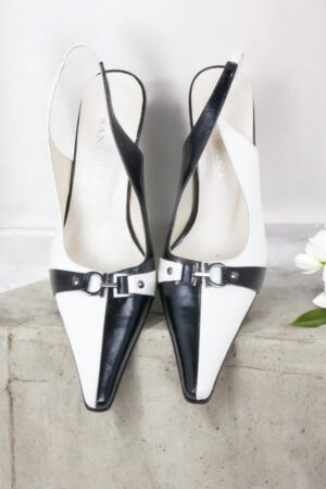 Black and white leather open-heel shoes.