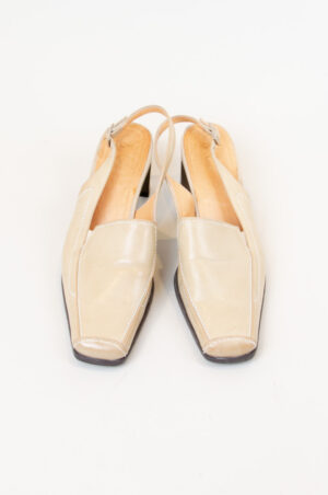 Beige leather open heel shoes.