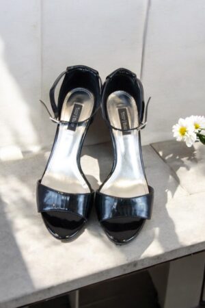 Patent leather sandals.