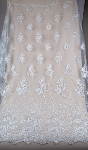 Natural white embroidered tulle fabric with a wide decorative border