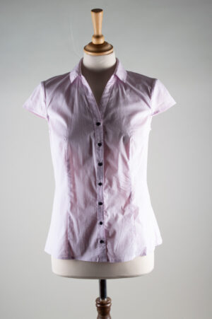 pale pink blouse with small black dots and a deep V-neckline