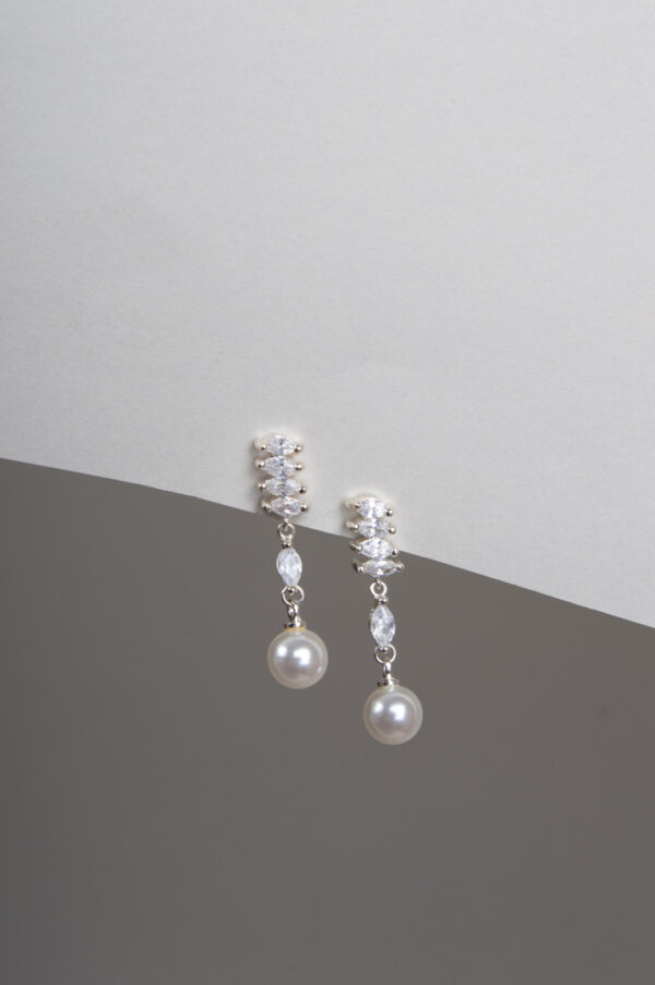 Dangling pearl and zircon crystal earrings.