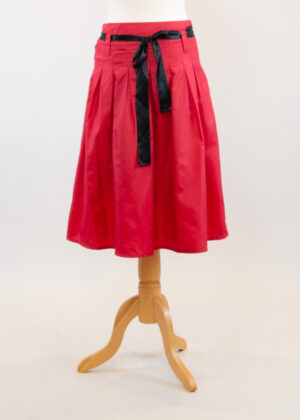 Pleated red taffeta skirt.