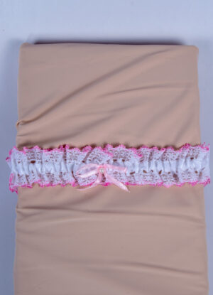 The garter of white lace with a pink border with white satin ribbon is decorated with a pink ribbon tie.