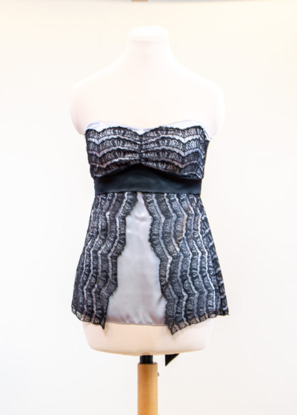 Strapless grey top covered with black lace
