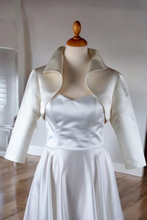 Festive bolero made of natural white satin.