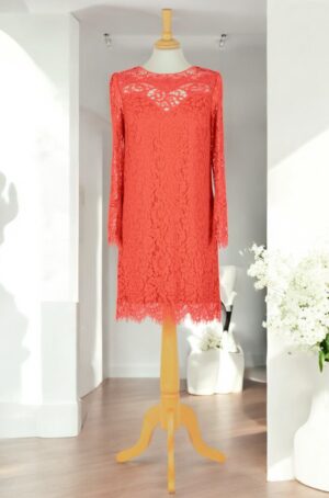 Straight-cut red lace dress with long sleeves.